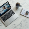 Real estate agent using AI tools on laptop to write listing descriptions and follow up with leads faster in